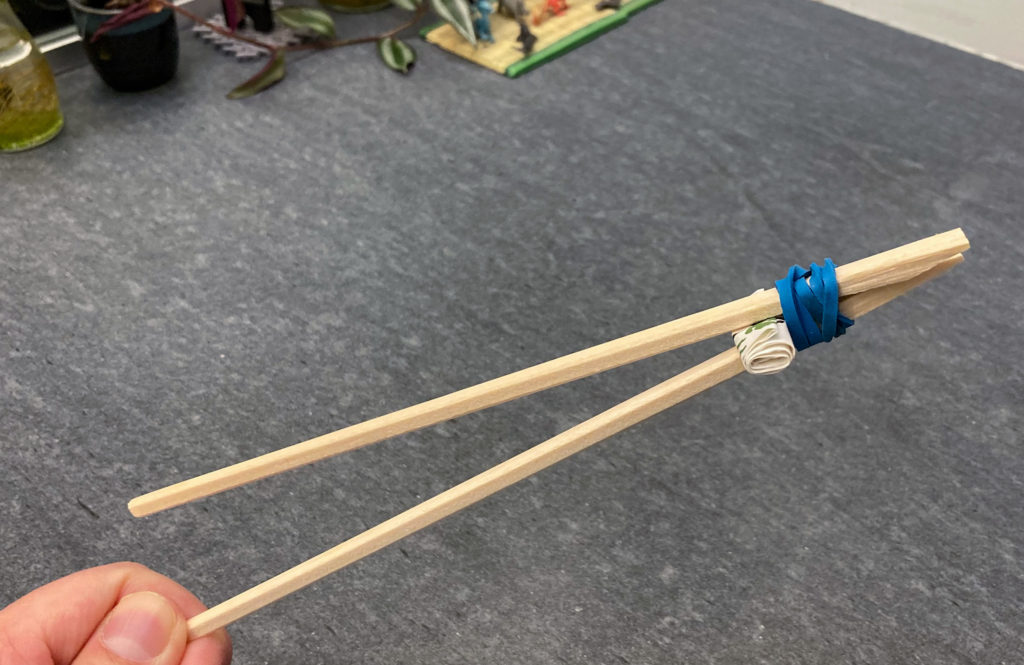 Tweezer chopsticks - Kiddie chopsticks made with wrapper sleeves and rubber band